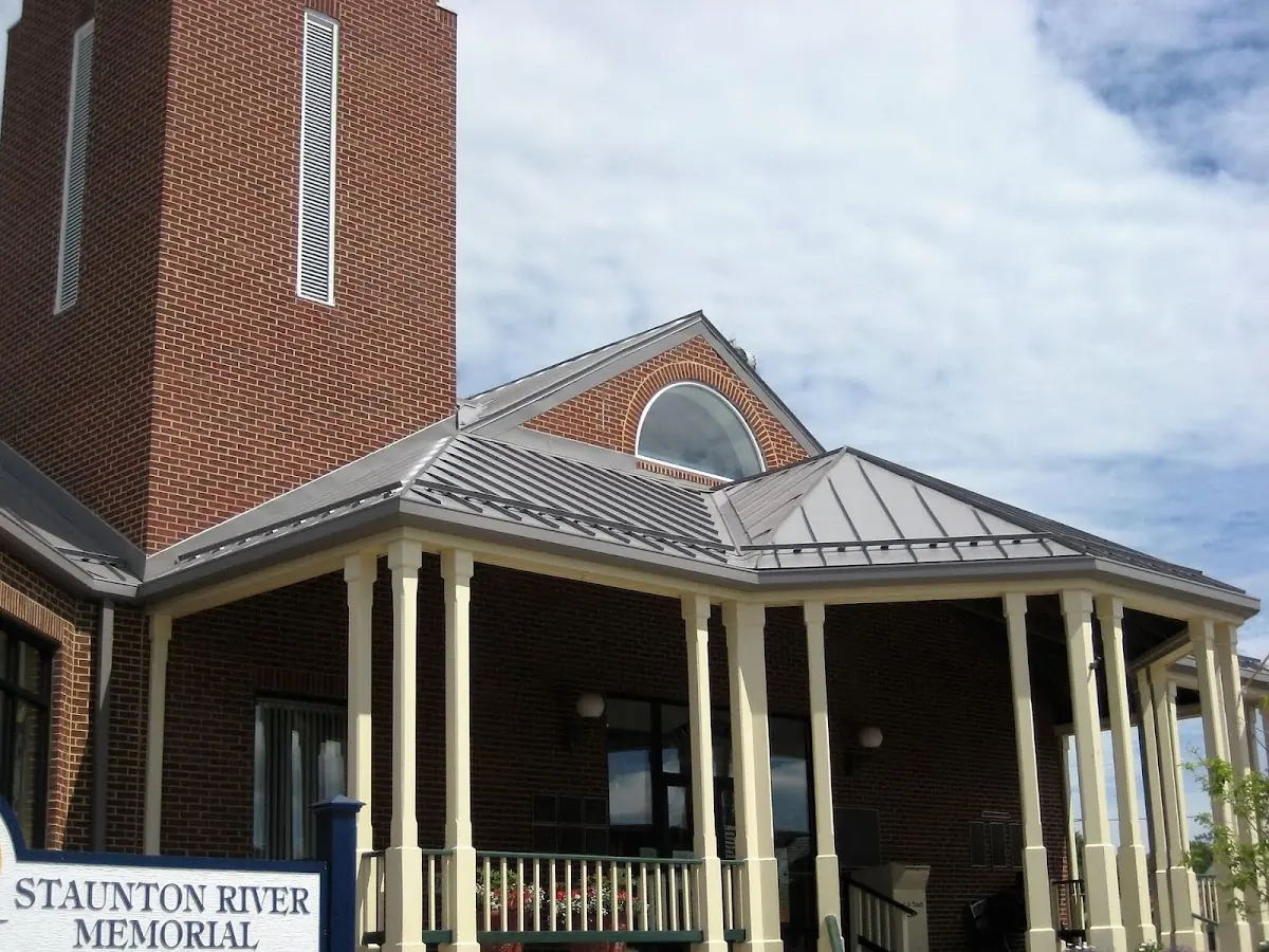 Skilled roofing craftsmen working on a residential roof in Dennison